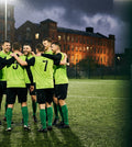 Five-a-side team in matching custom kits with their own crest